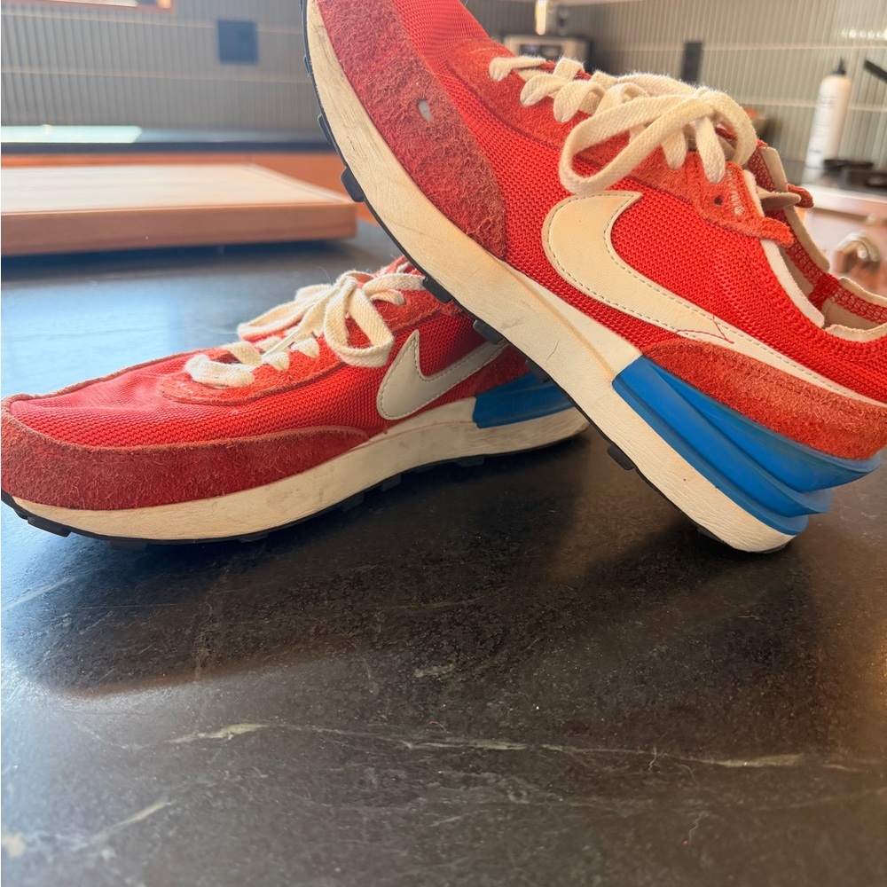 Nike Red Sneakers with Blue Heel Accents and Cream Swoosh